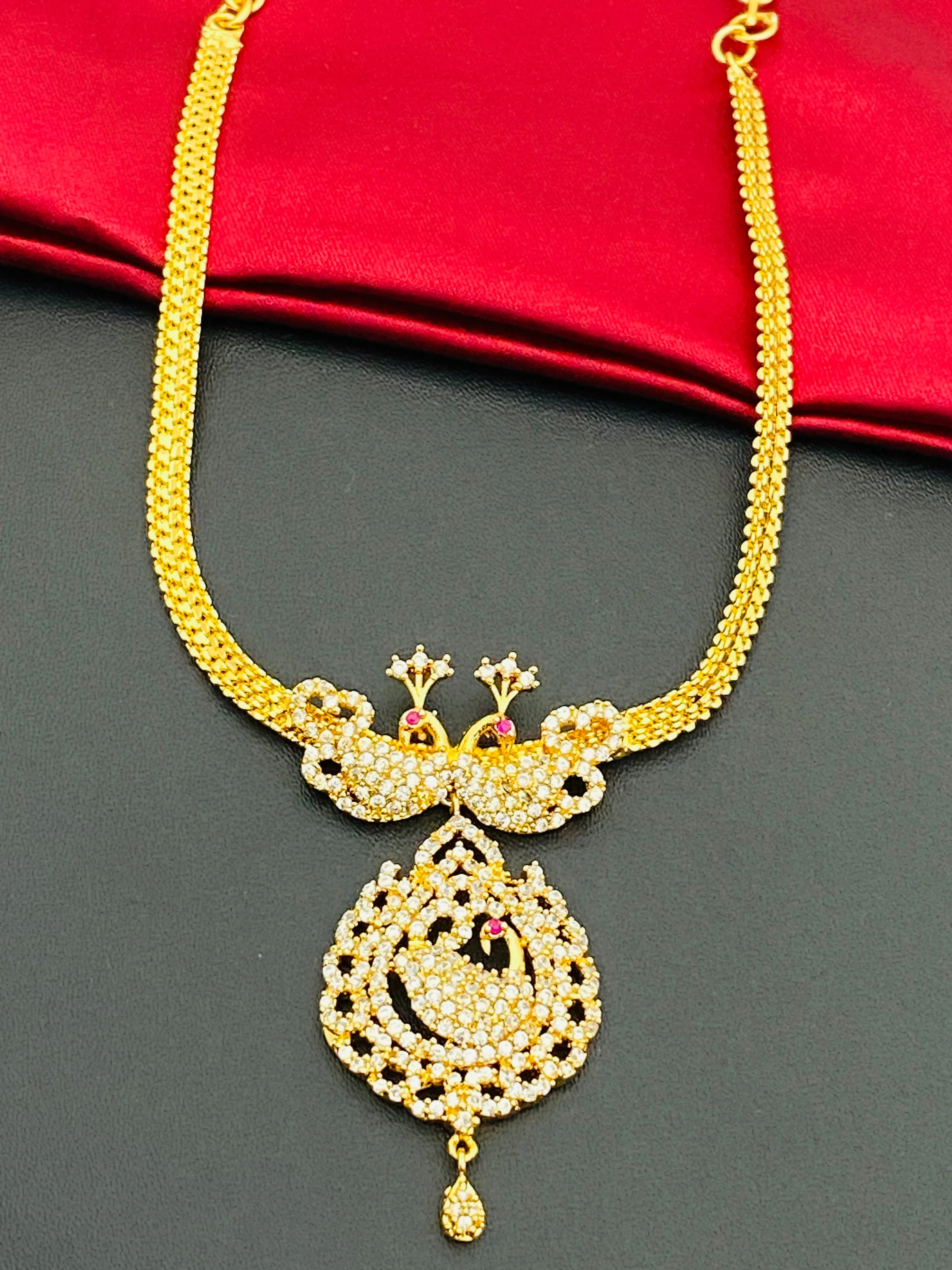 Appealing Gold Plated White Stoned Necklace With Peacock Pendant