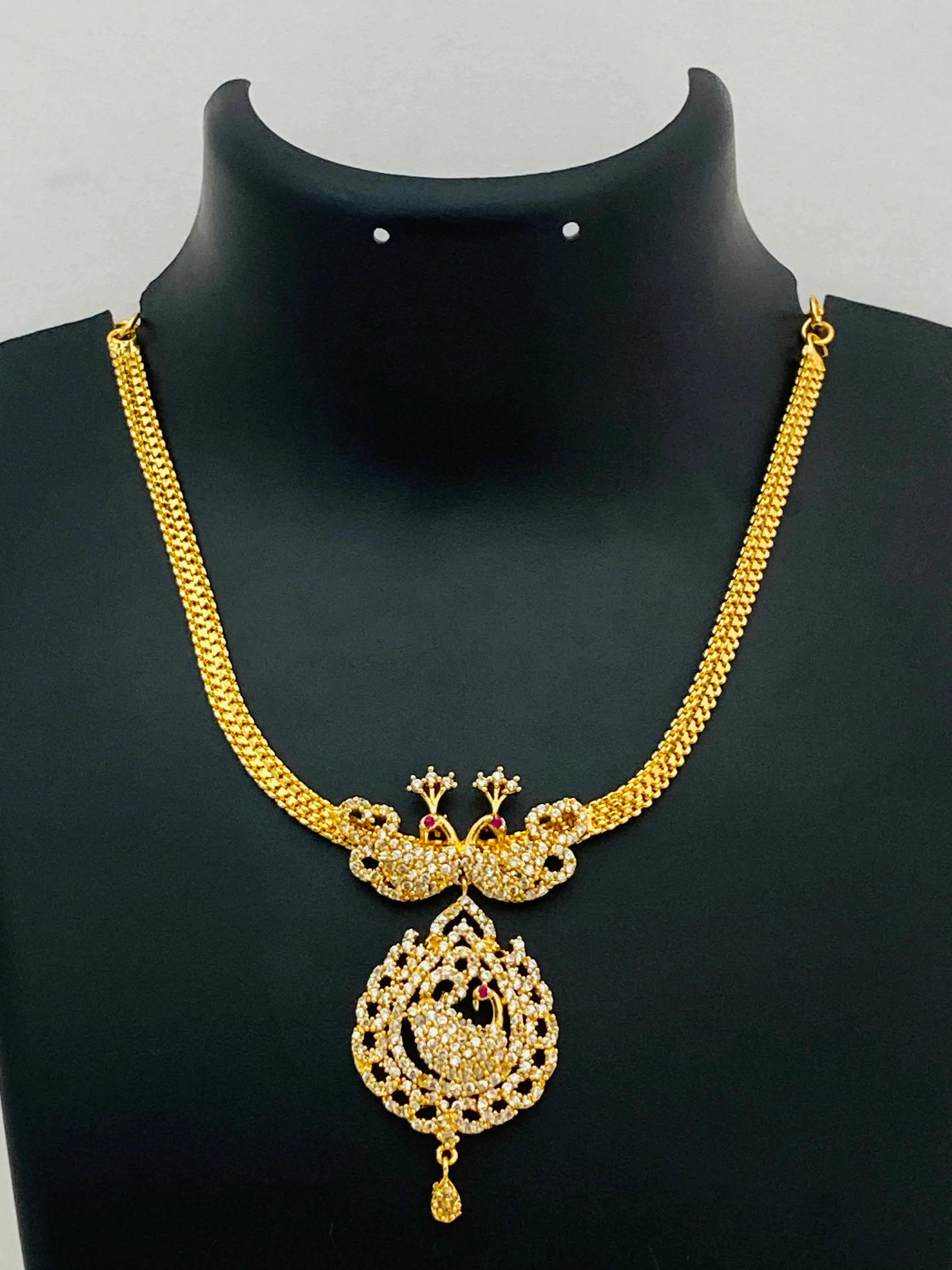 Appealing Gold Plated White Stoned Necklace With Peacock Pendant