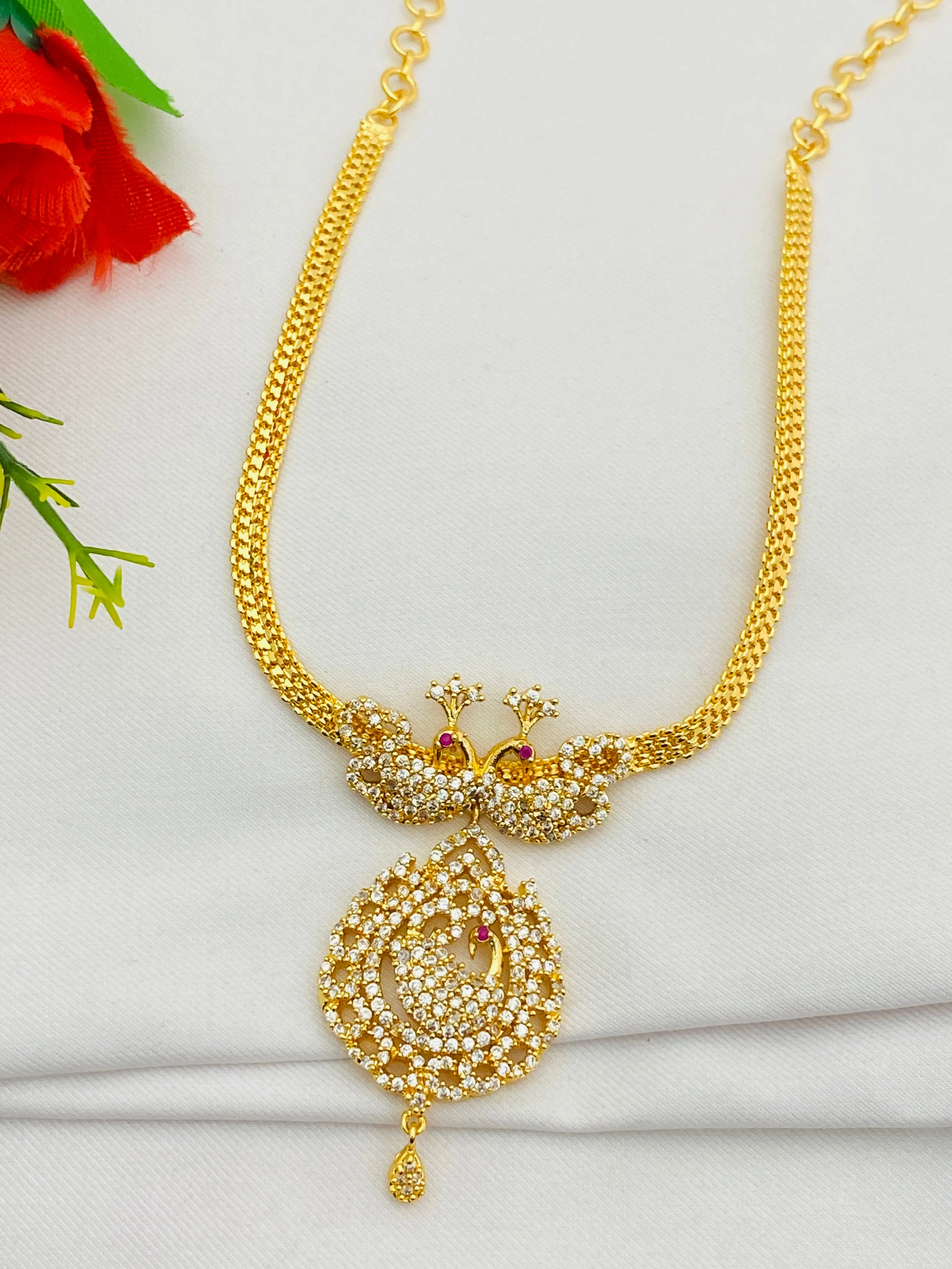 Appealing Gold Plated White Stoned Necklace With Peacock Pendant