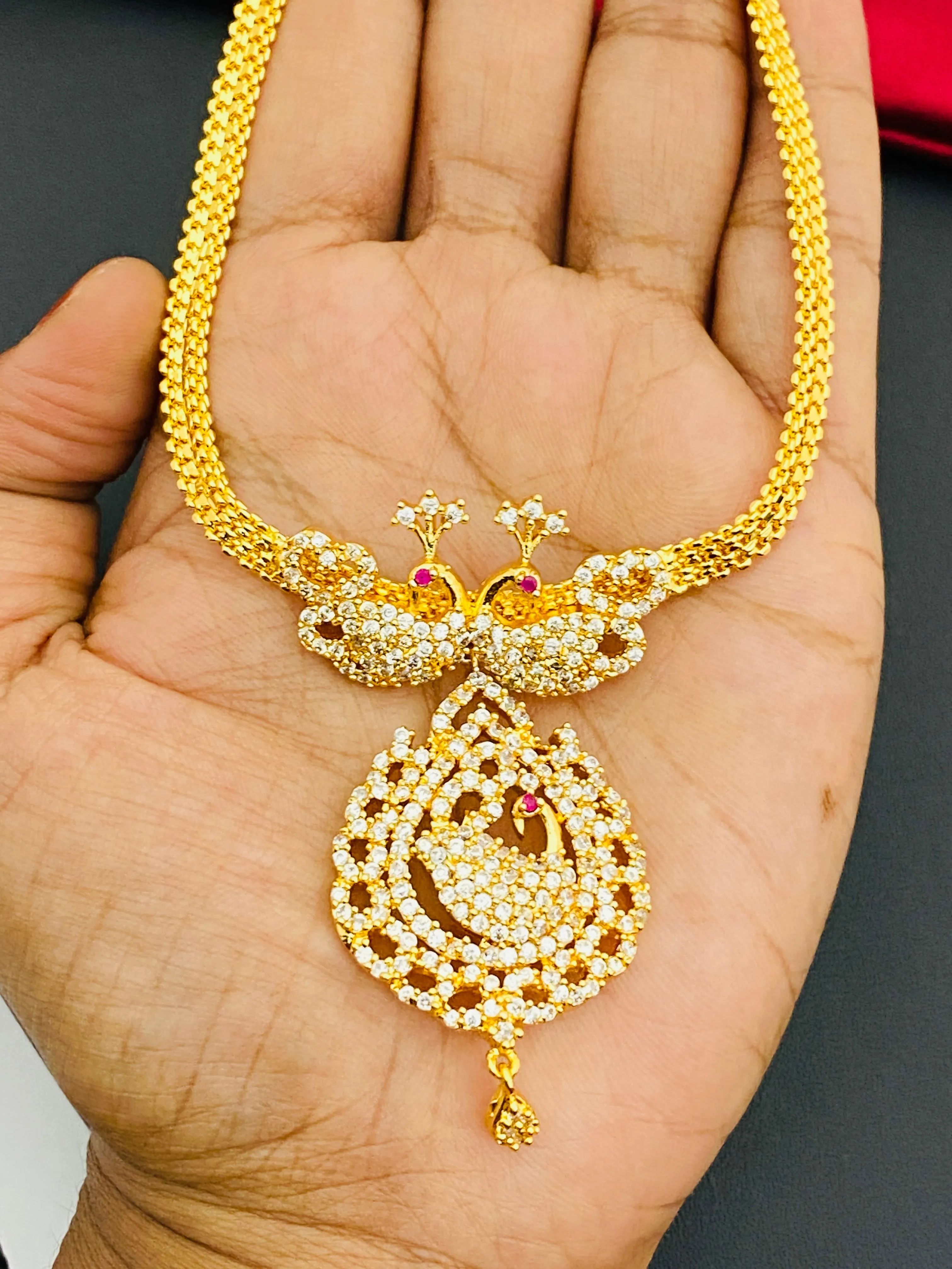 Appealing Gold Plated White Stoned Necklace With Peacock Pendant