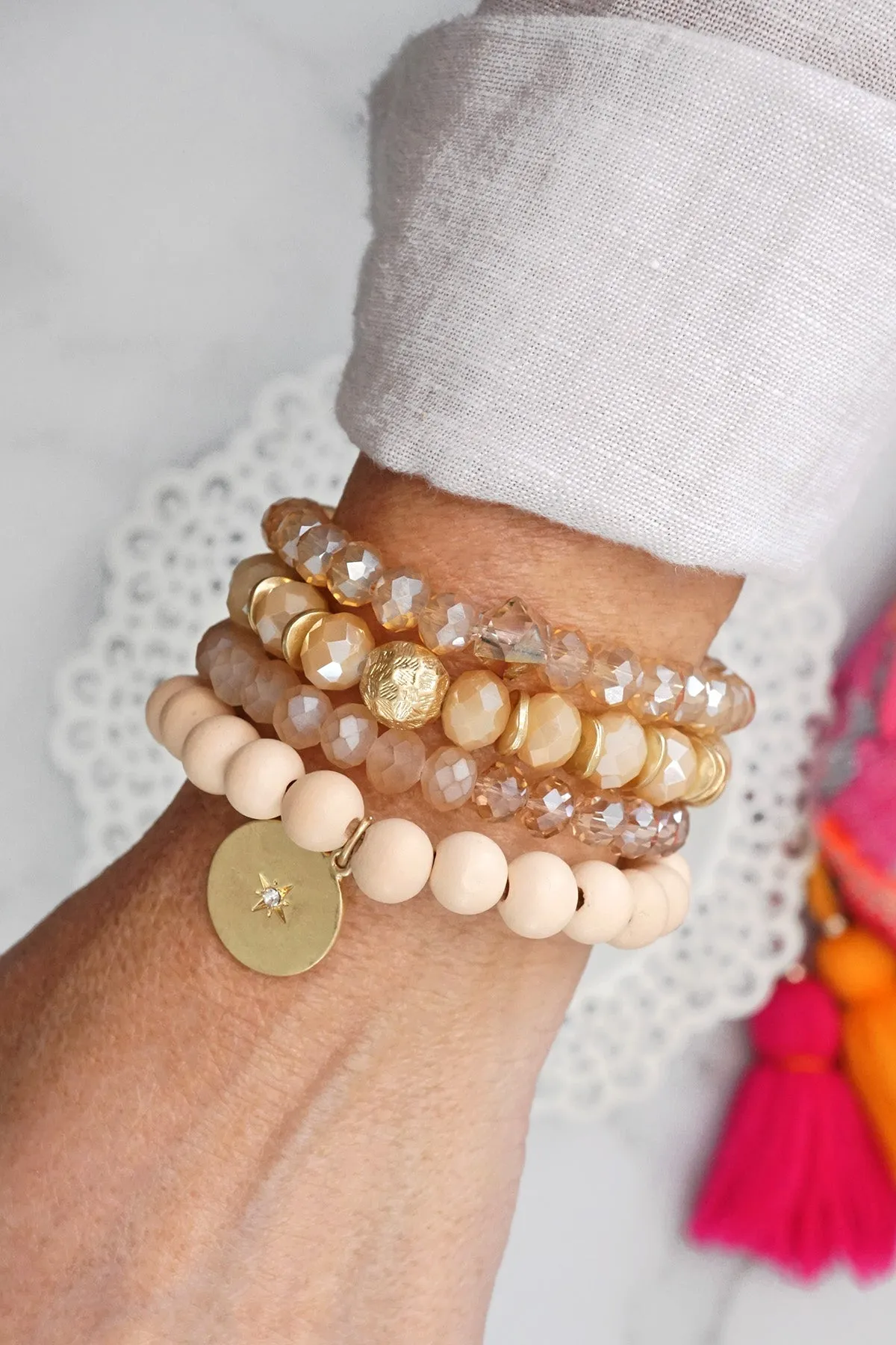 Beaded bracelets set in Neutral Ivory Cream with a coin charm