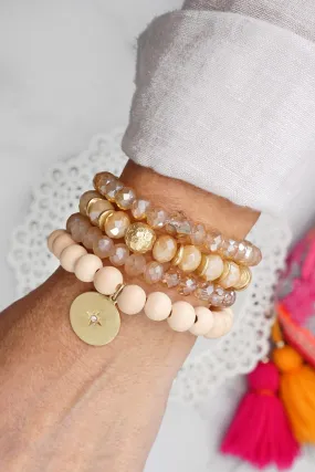 Beaded bracelets set in Neutral Ivory Cream with a coin charm